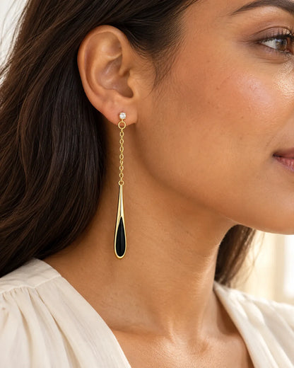 Close-up of a model wearing the long black teardrop chain earring