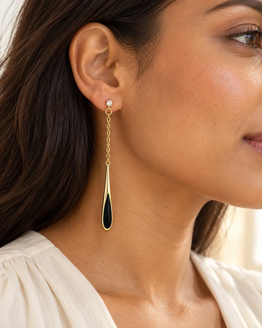 Close-up of a model wearing the long black teardrop chain earring