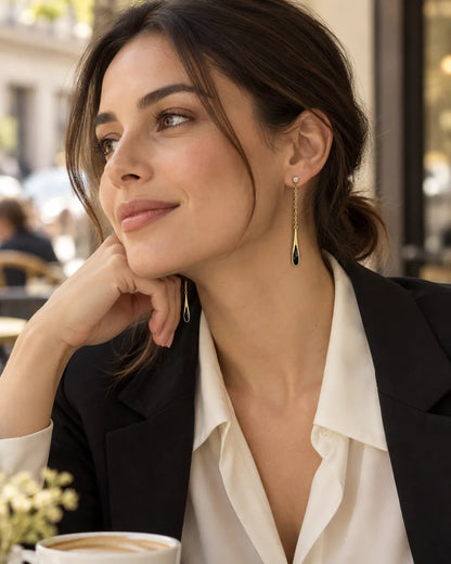 Model in a black blazer at a cafe wearing the black teardrop drop earrings
