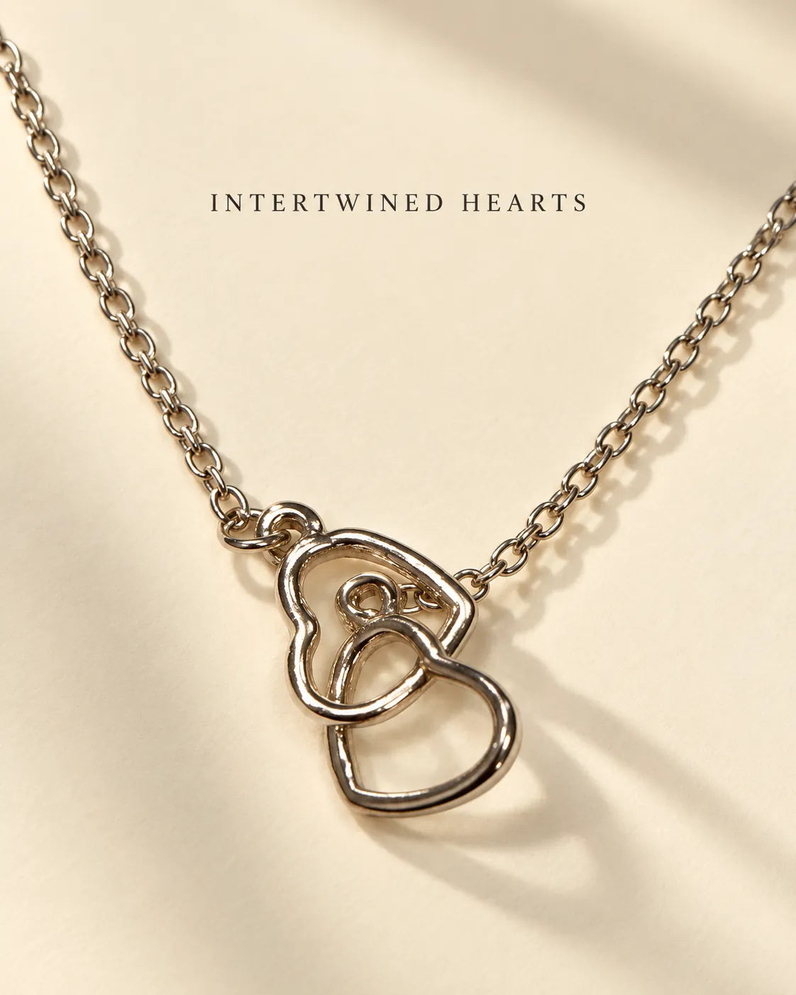 Silver interlinked hearts necklace with Intertwined Hearts text