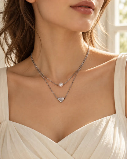 Model in a cream sweetheart top wearing the two-layer silver necklace