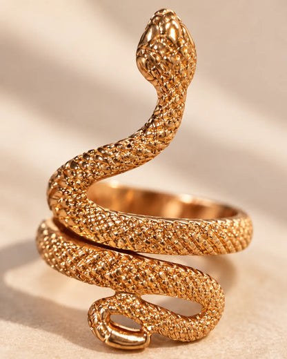 Close-up of the gold snake ring's coiled body and sculpted head