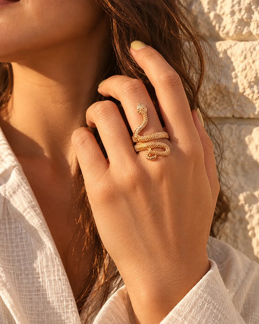 Model's hand near her face wearing the gold snake ring