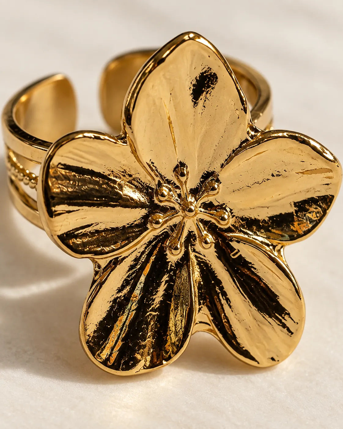 Close-up of the veined, curved petals of the gold flower ring