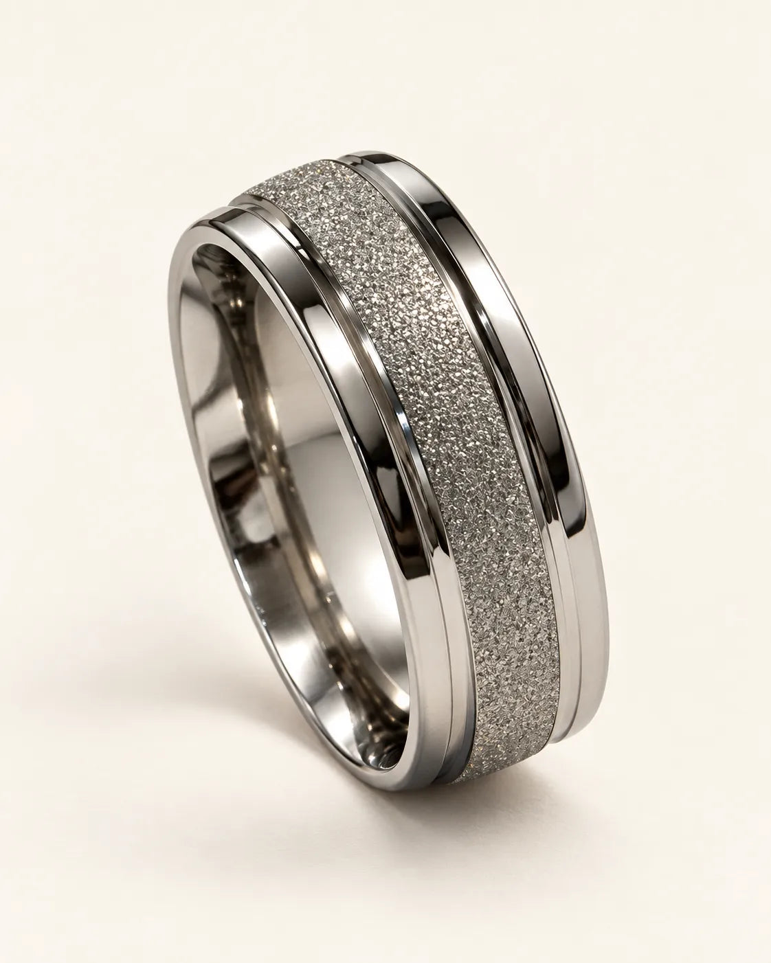 Silver Eternite band ring with frosted centre and polished edges on a cream background