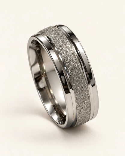 Silver Eternite band ring with frosted centre and polished edges on a cream background