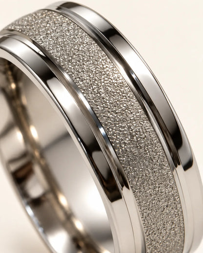 Close-up of the frosted sand-blasted channel and polished rims of the silver ring