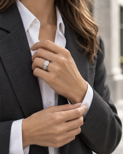 Woman in a black blazer wearing the silver textured band ring