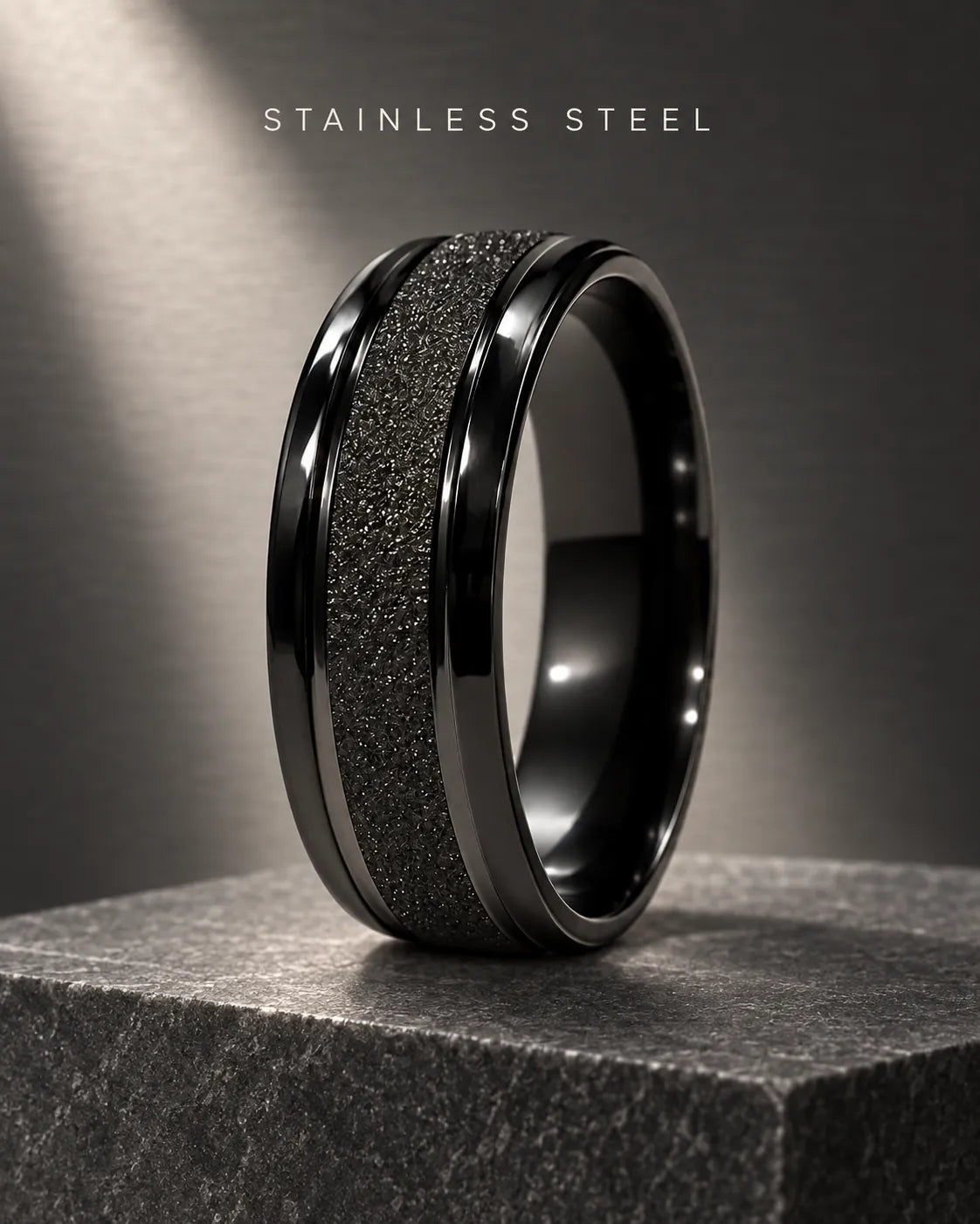 Black textured band ring on a dark stone block
