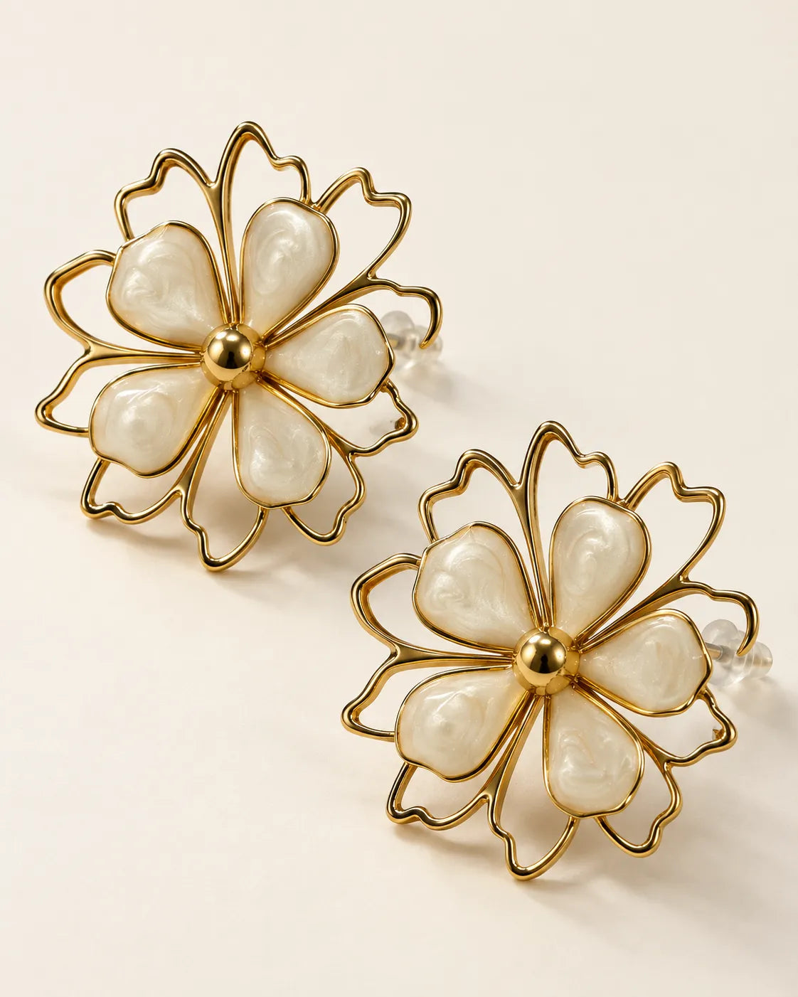 Angled view of the ivory petal flower studs and gold bead centres