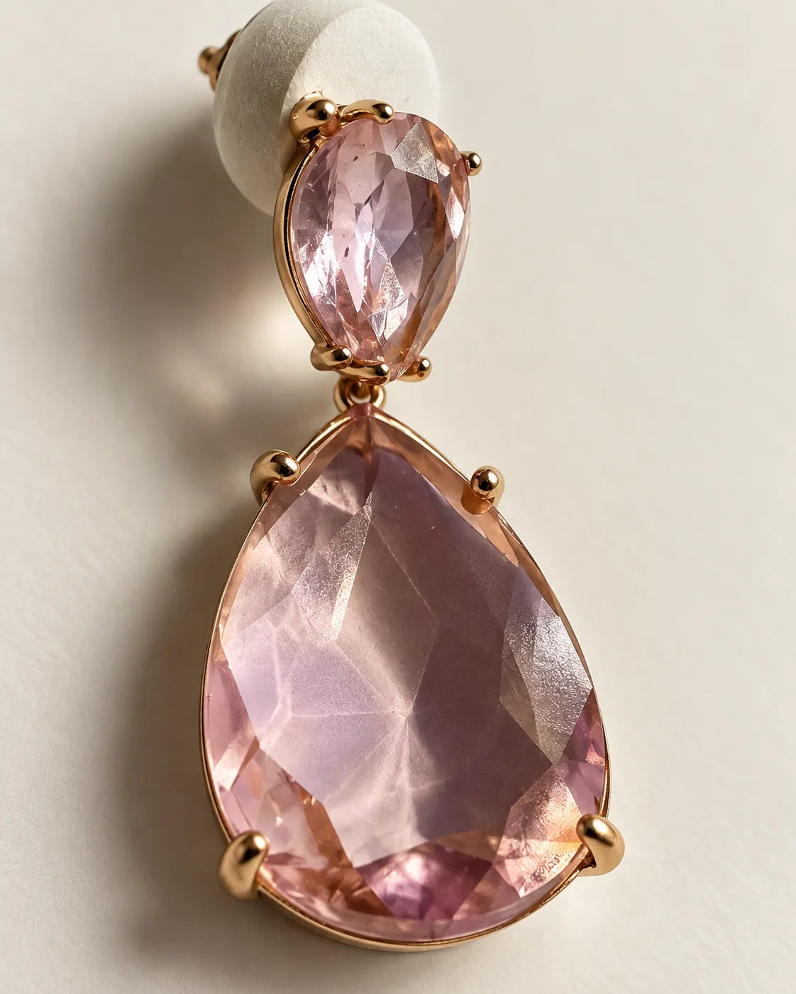 Close-up of the pink pear-cut crystals and gold-tone claw setting