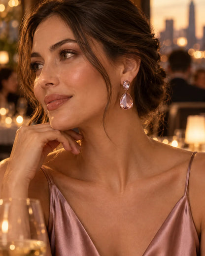 Model in a rose satin slip dress wearing the pink teardrop earrings at an evening event