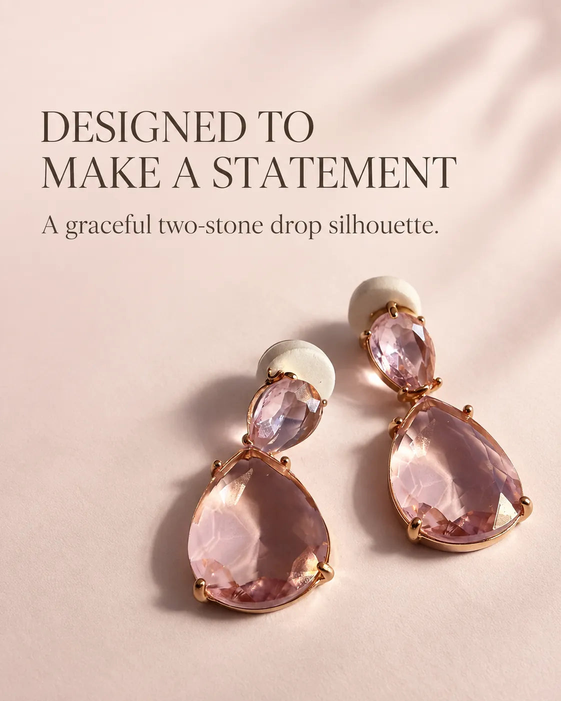 Styled graphic of the pink two-stone drop earrings on a blush backdrop