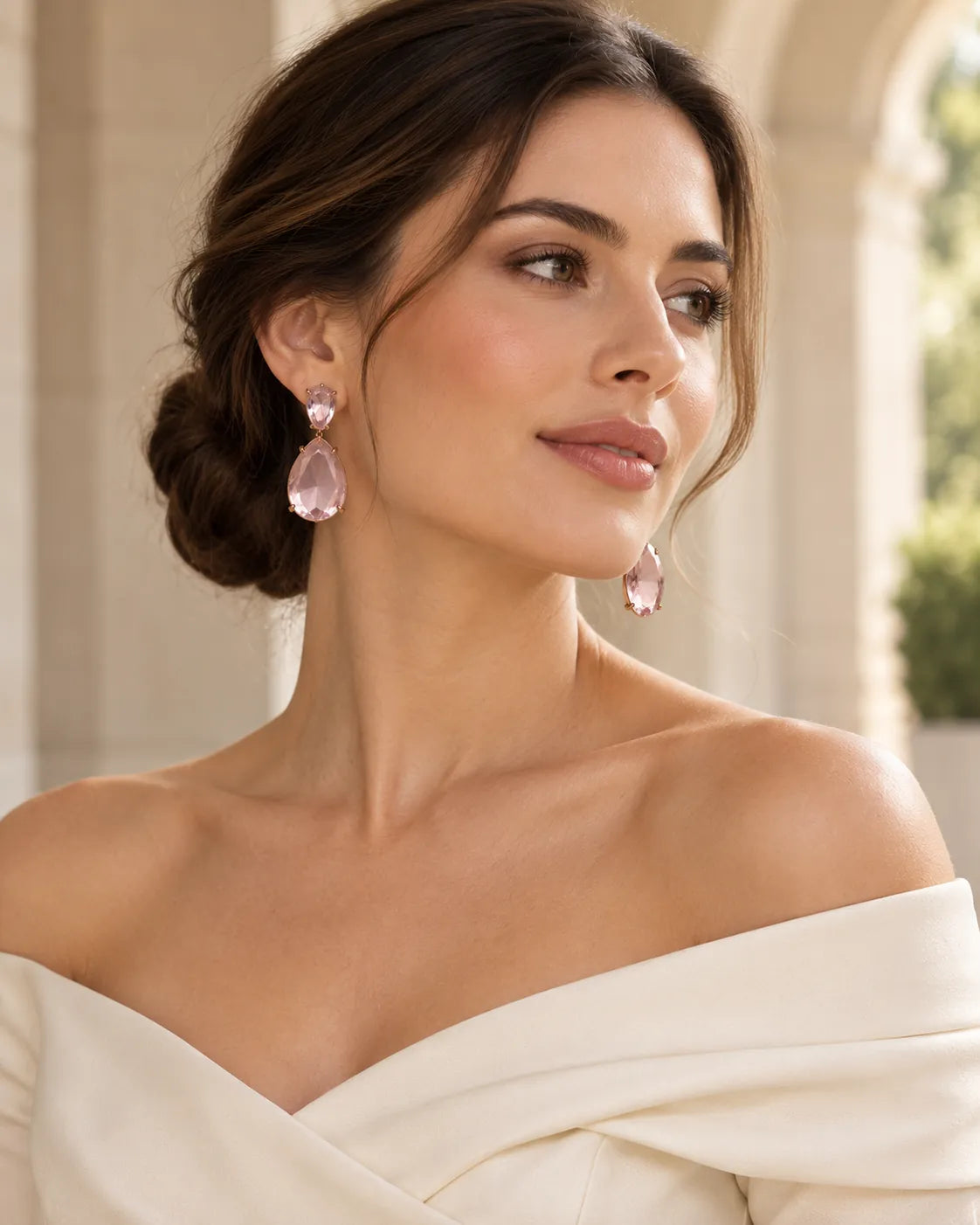 Model with an updo and off-shoulder cream top wearing the pink teardrop earrings