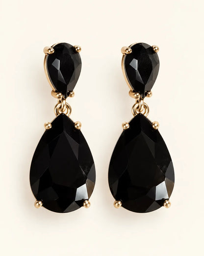 Black Elara two-stone teardrop earrings on a cream background