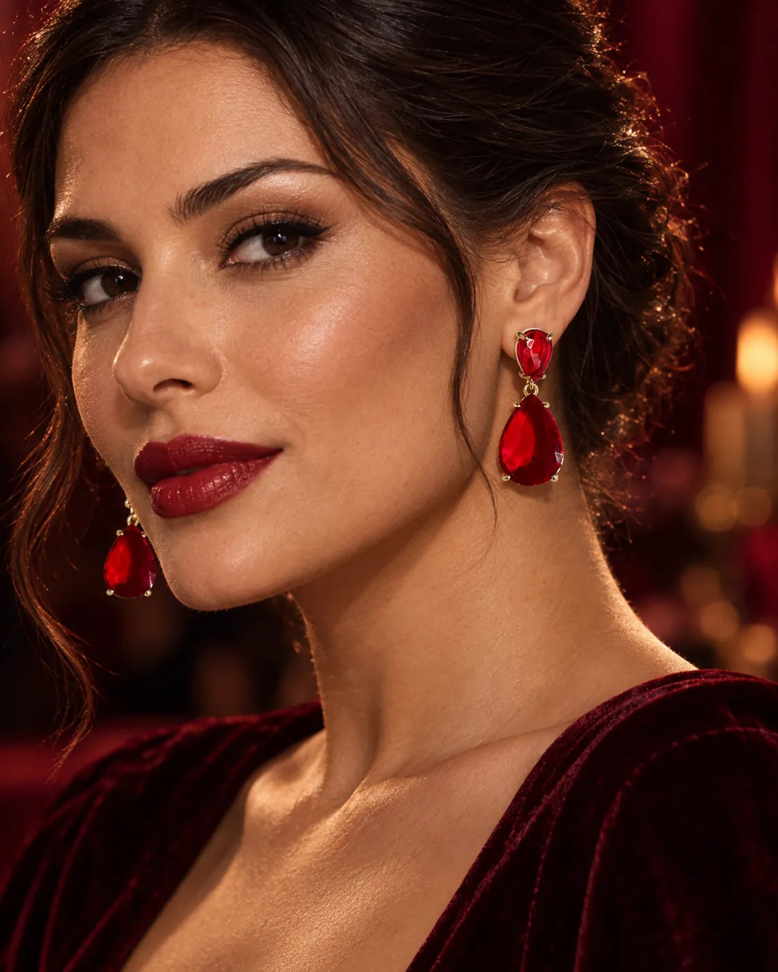 Model in burgundy velvet with a red lip wearing the red crystal drop earrings
