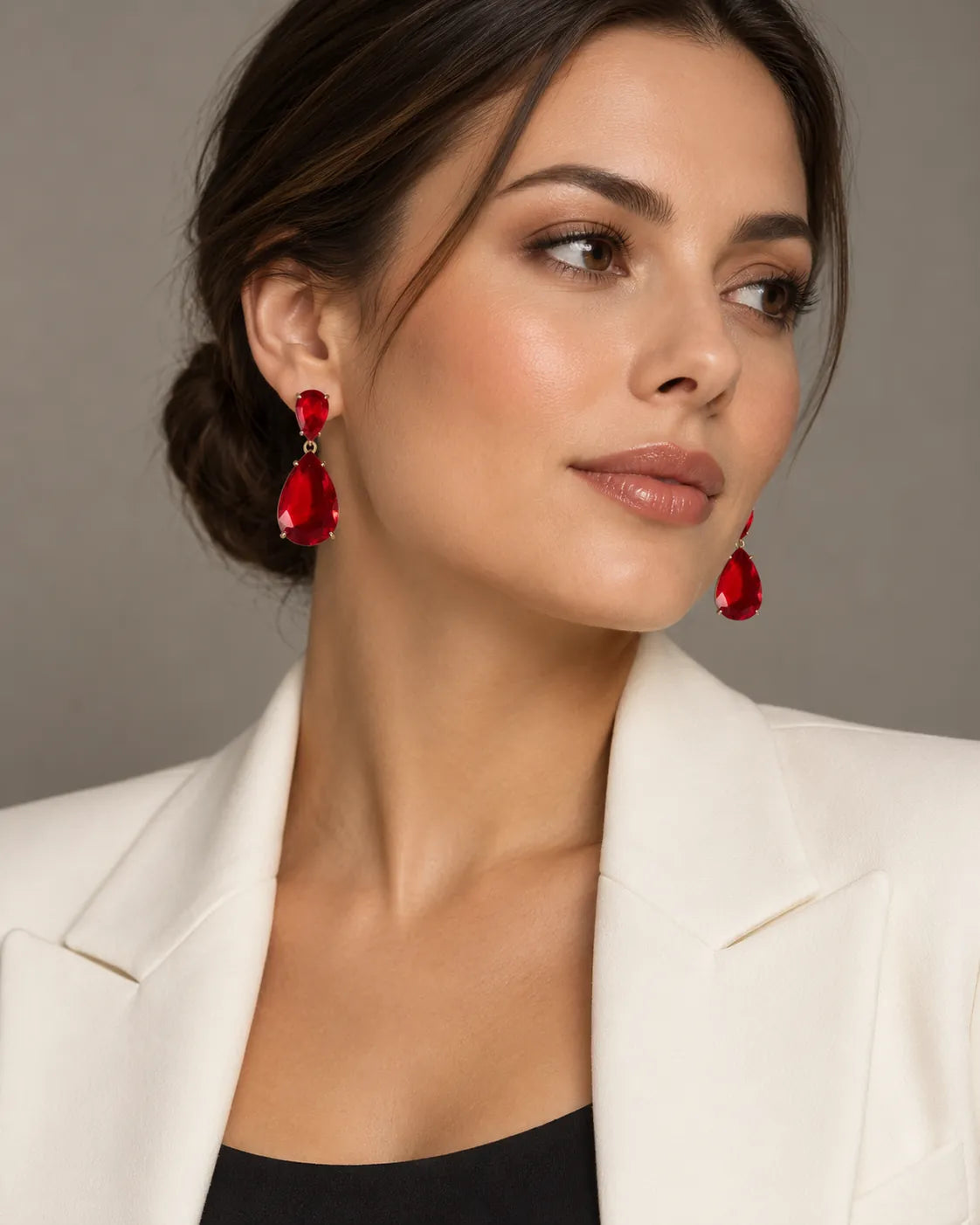 Model in a white blazer wearing the red crystal teardrop earrings
