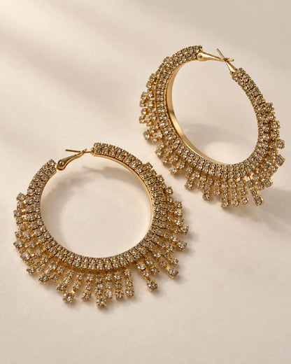 Aurelia gold-tone crystal fringe hoop earrings on a cream background