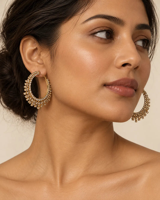 Model wearing the large gold crystal fringe hoops with hair pulled back