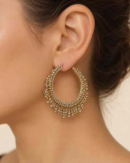 Close-up of a model's ear wearing the gold multi-layer crystal hoop