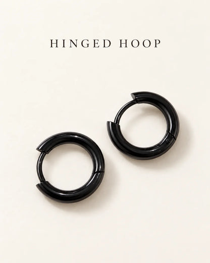 Black hinged huggie hoops on a cream card with Hinged Hoop text