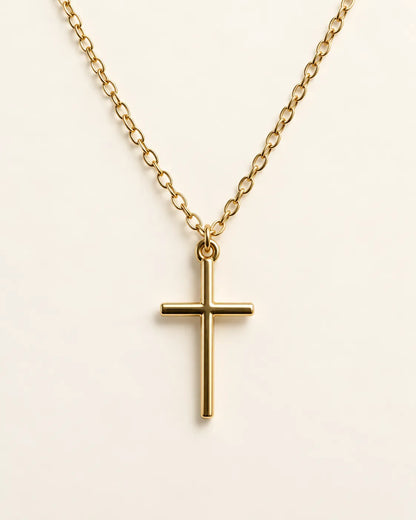 Gold-tone Élodie cross pendant necklace on a cream background