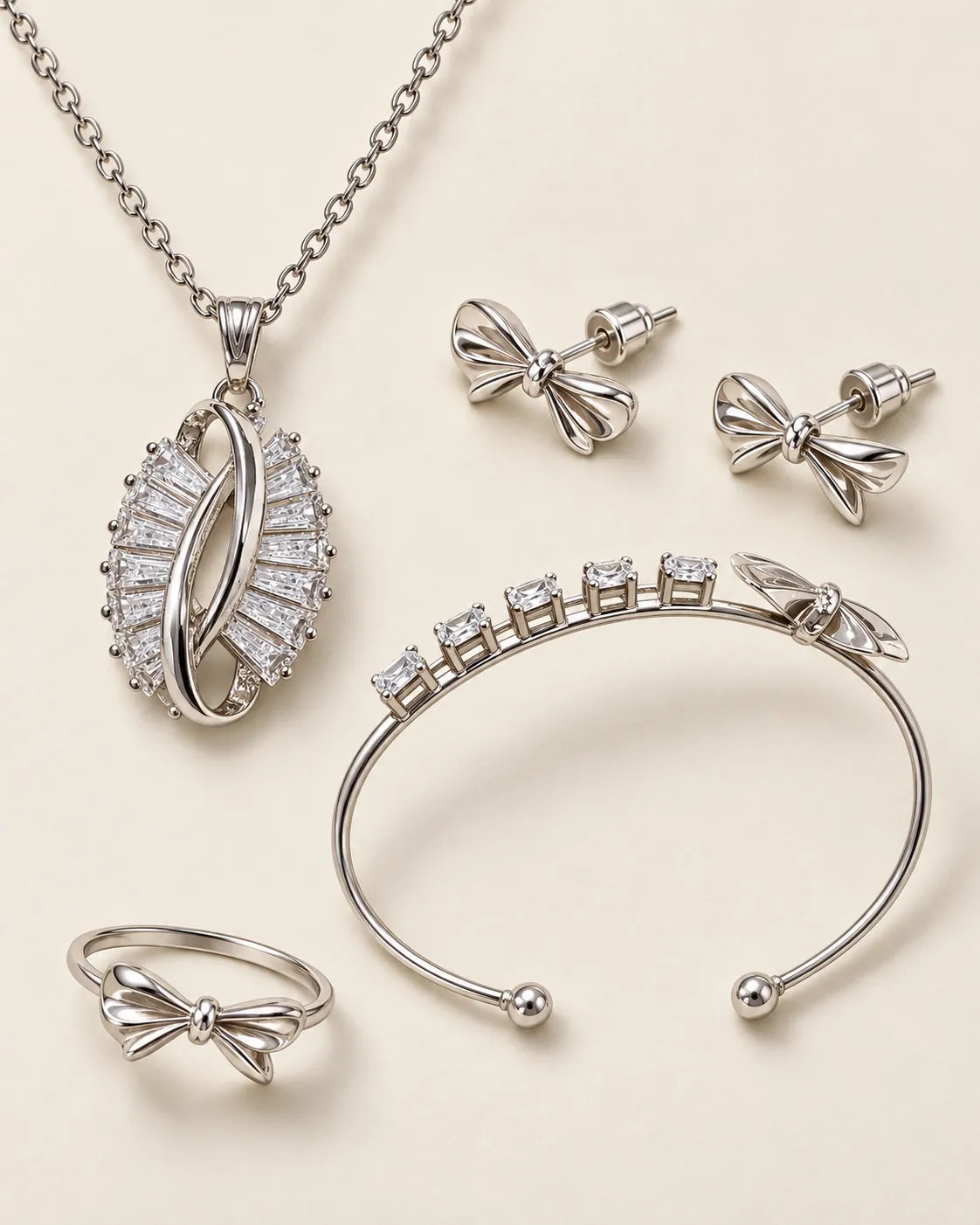 Silver-tone zircon bow set with necklace, studs, cuff and ring on cream