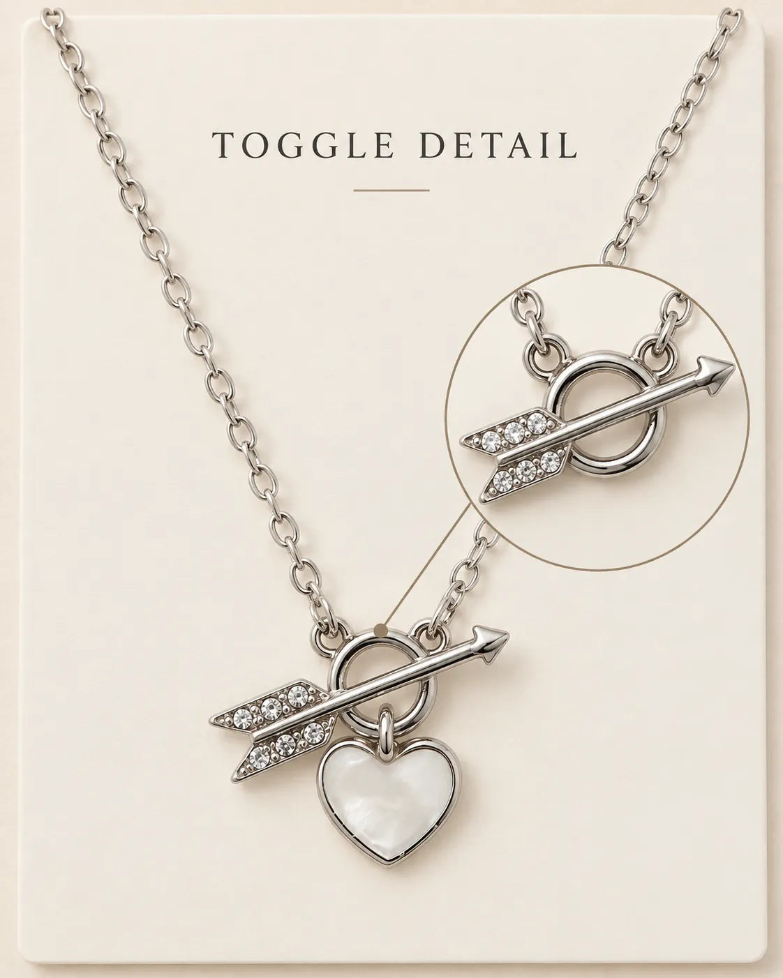 Silver toggle necklace with Toggle Detail text and a magnified arrow