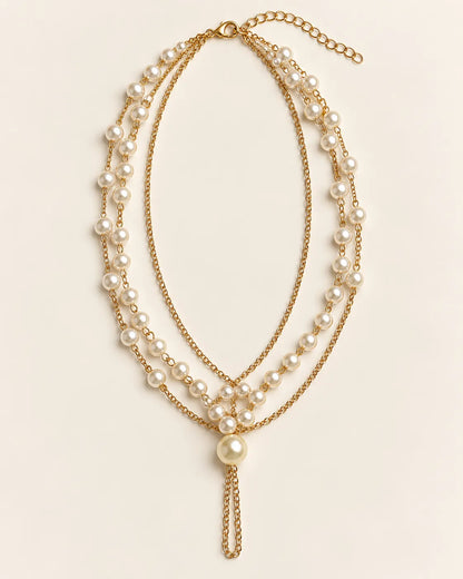 Gold Élan three-layer pearl-style necklace with Y-drop on cream