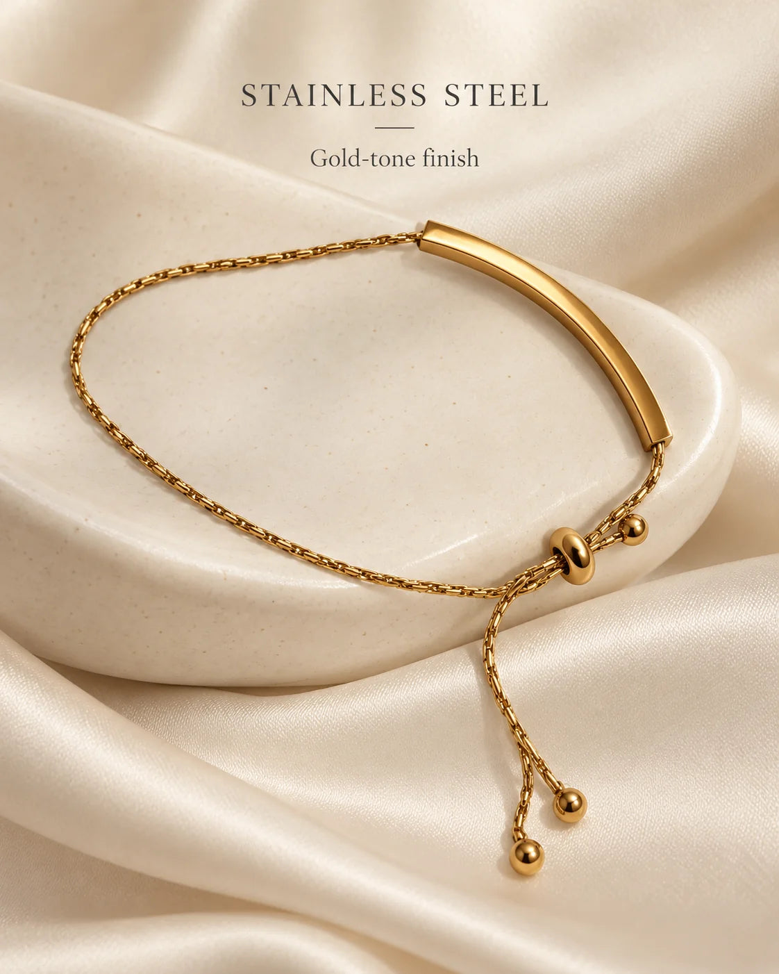Stainless steel gold-tone bar bracelet on ivory satin
