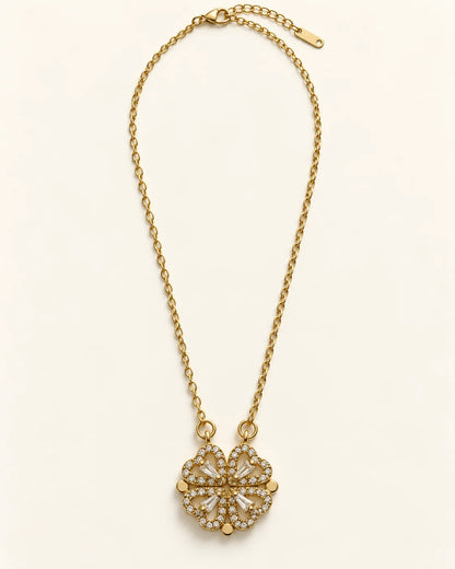Full length of the Amora gold four-heart clover necklace laid flat with its extender chain