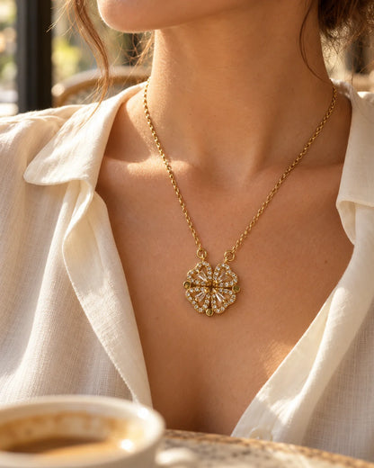 Amora gold clover necklace worn with a linen shirt in soft café light