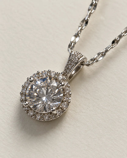 Close-up of the Luna round halo pendant showing the centre stone, stone-set halo and bail