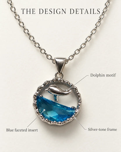 Delphine design details card highlighting the dolphin motif, blue faceted insert and silver-tone frame