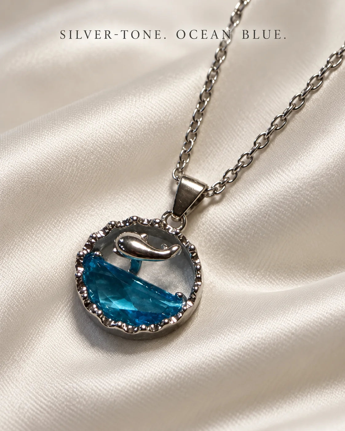 Silver-tone, ocean blue: Delphine dolphin pendant on ivory satin