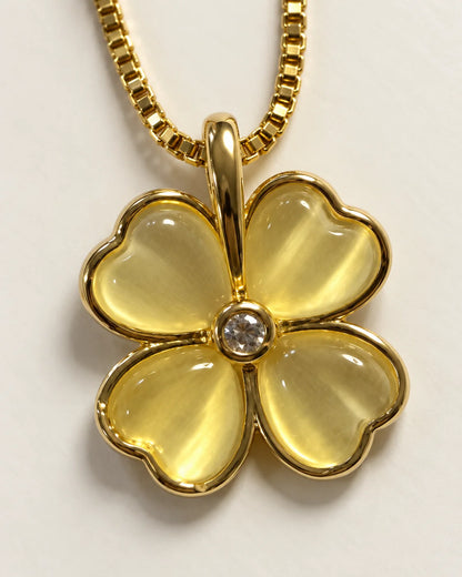 Close-up of the Primrose pendant showing the yellow heart-shaped petals and clear centre stone