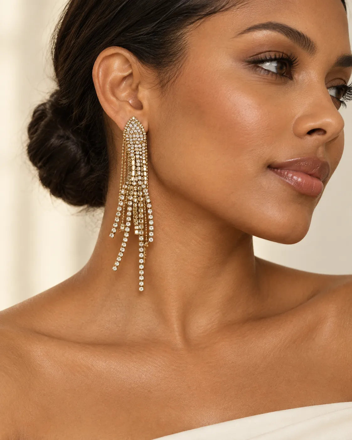 Model with an updo wearing the long rhinestone tassel earrings