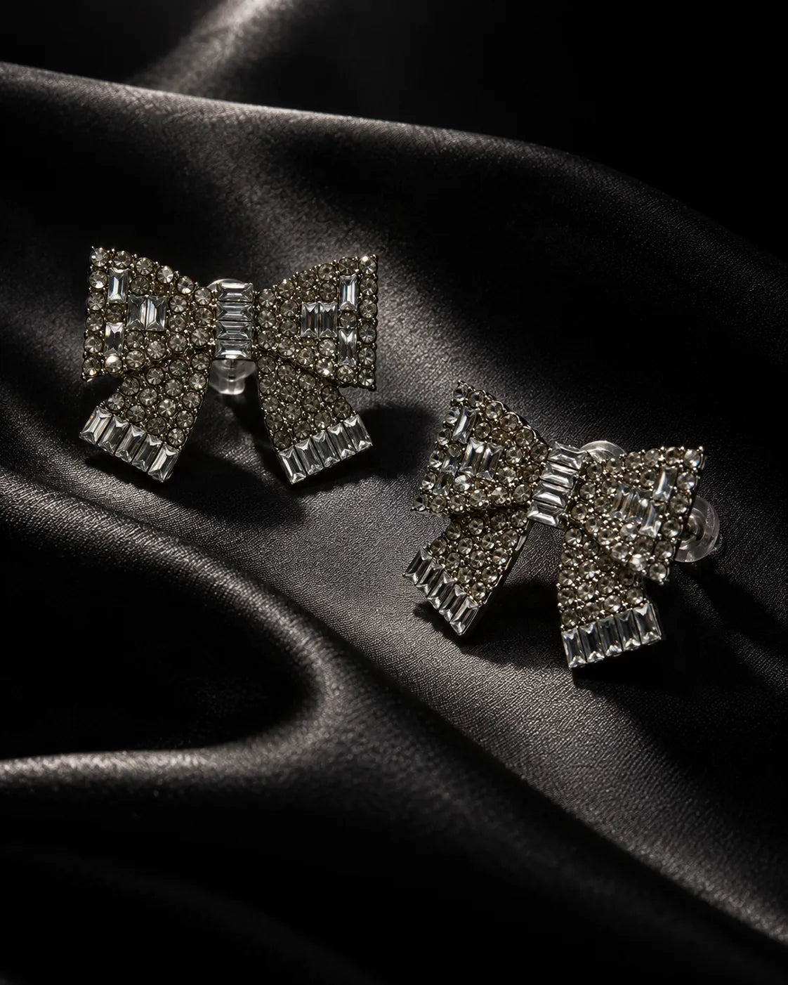 Clear rhinestone bow studs on black satin