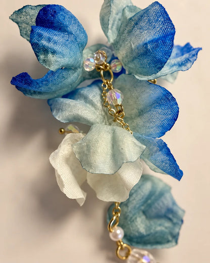 Close-up of the layered blue fabric petals and gold-tone crystal centre