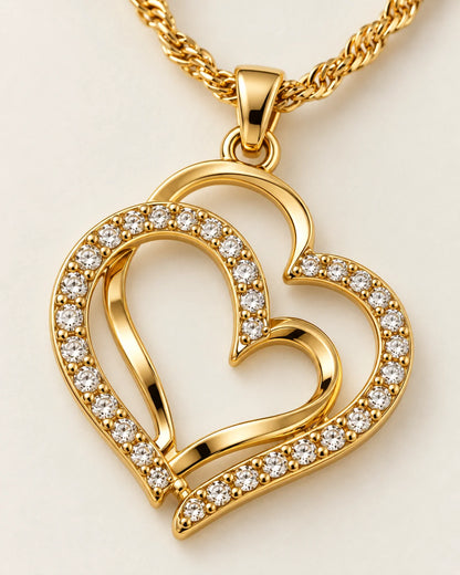 Close-up of the gold double heart pendant with clear rhinestones and a polished heart