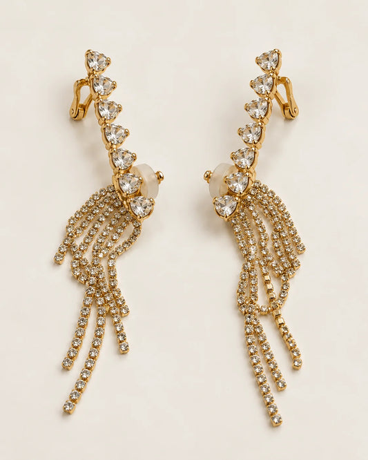 Cascade gold heart crystal tassel ear climber earrings, pair shown on cream