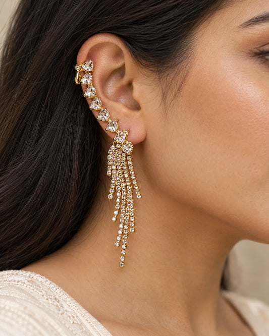 Close-up of a woman wearing the gold heart ear climber with crystal tassel fringe