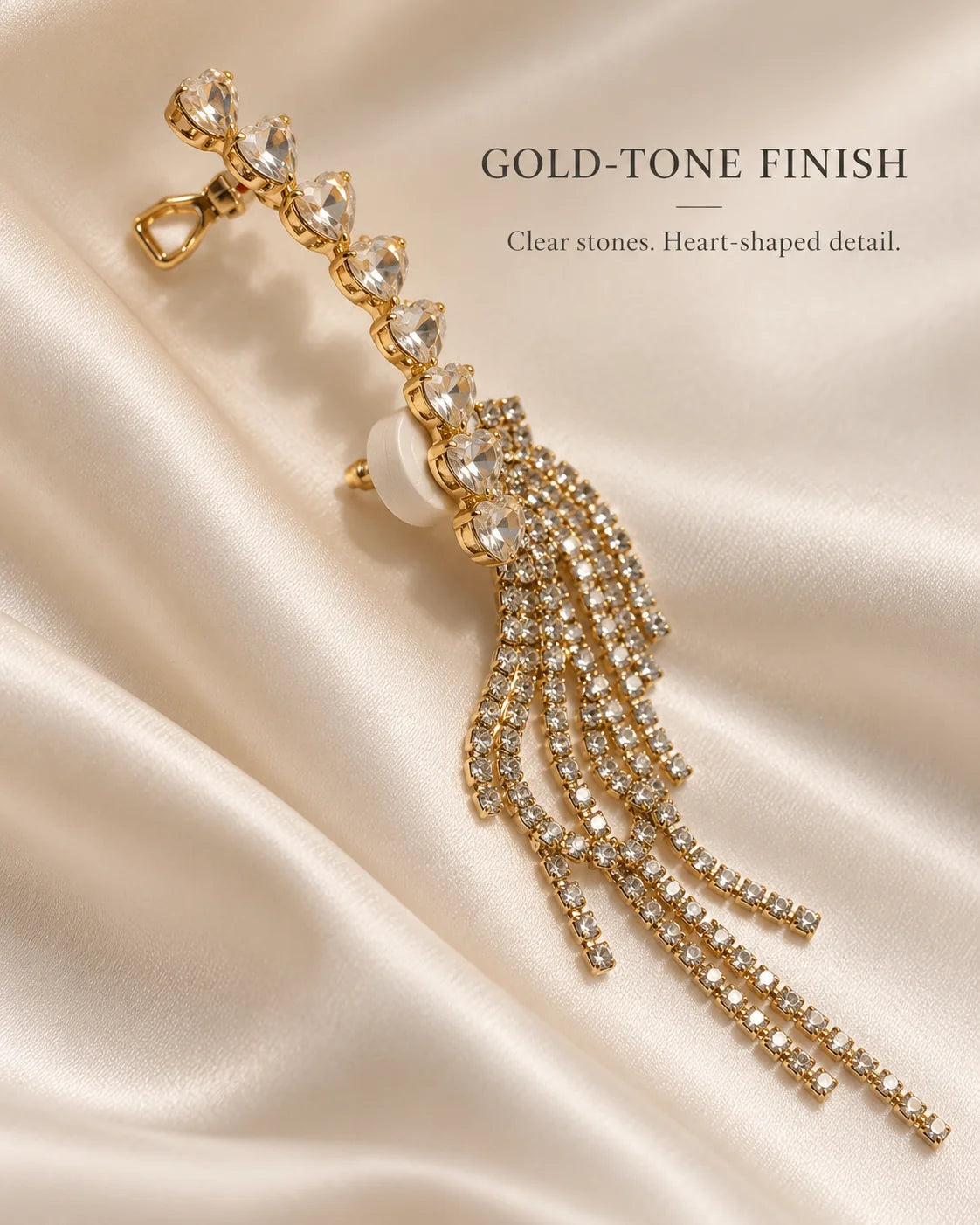Gold-tone finish ear climber with clear heart-shaped stones on ivory satin