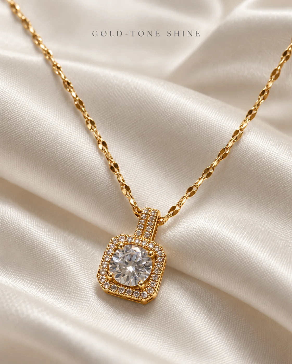 Gold-tone shine: Celeste cushion halo pendant on ivory satin