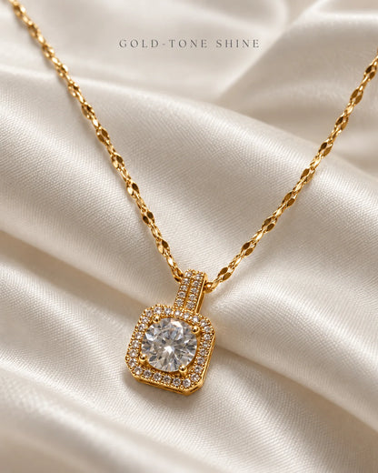 Gold-tone shine: Celeste cushion halo pendant on ivory satin