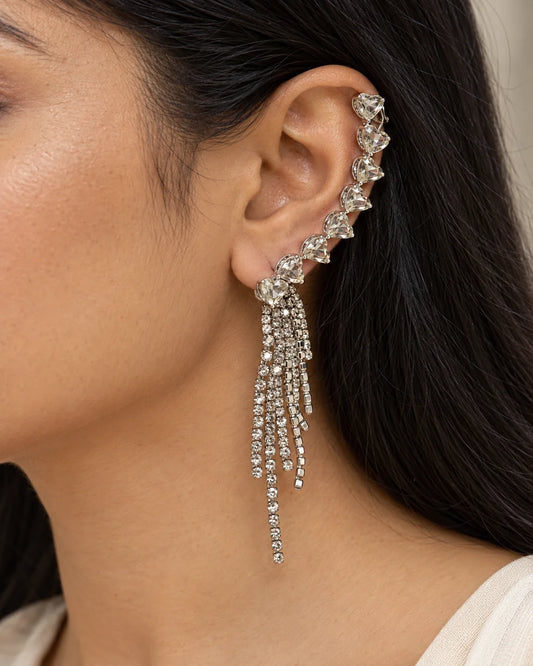 Close-up of a woman wearing the silver heart ear climber with rhinestone tassel fringe