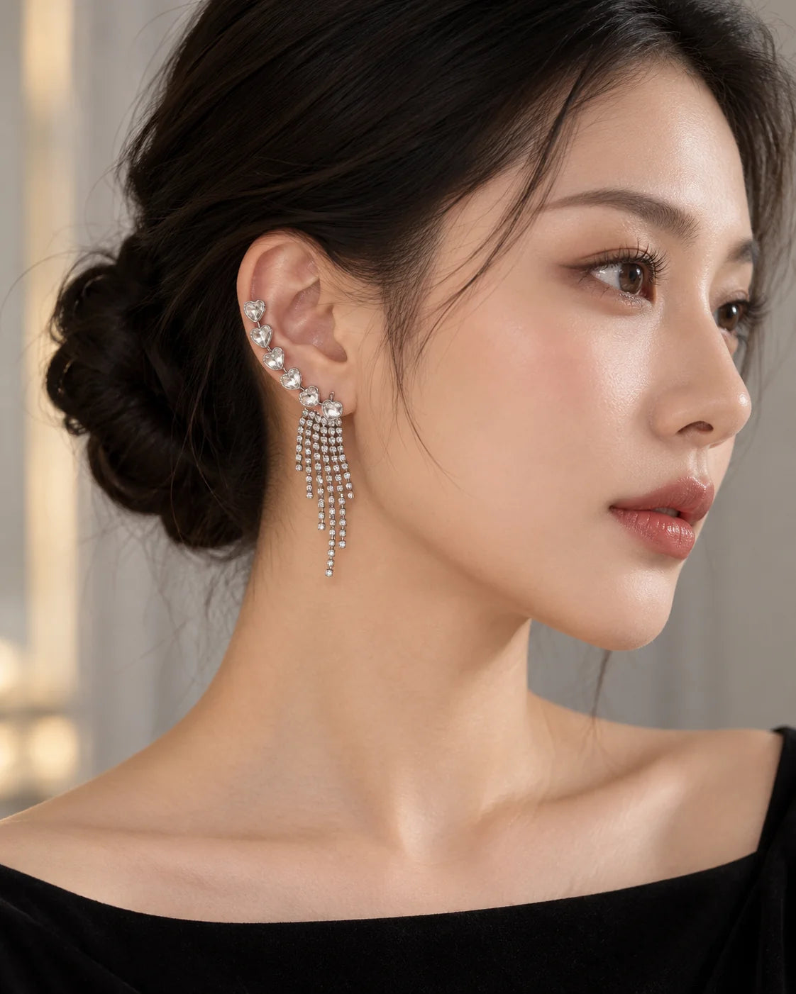 Woman in an elegant evening profile wearing the silver heart crystal ear climbers