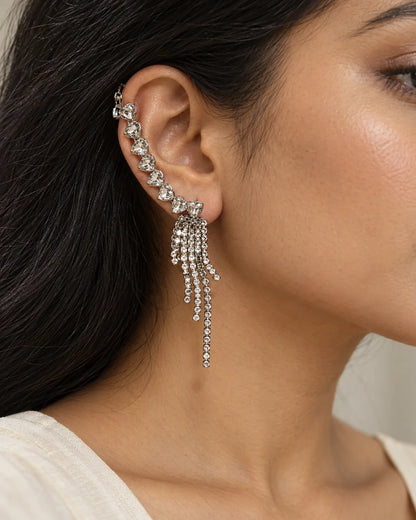Portrait of a woman wearing the silver heart crystal tassel ear climber