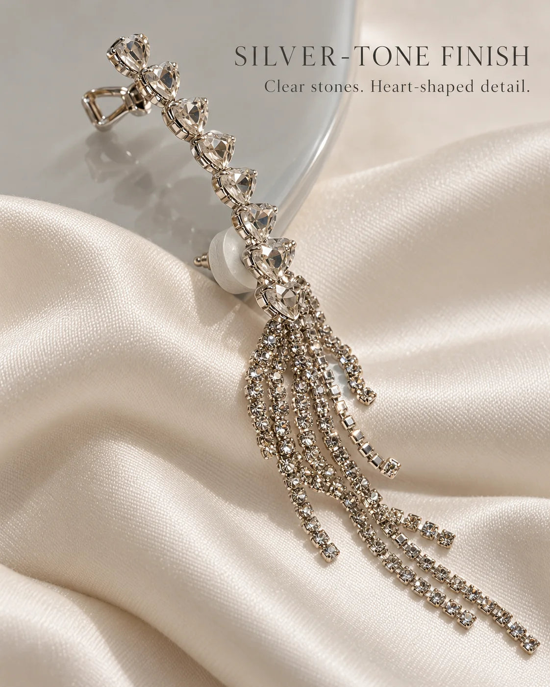 Silver-tone finish ear climber with clear heart-shaped stones on ivory satin