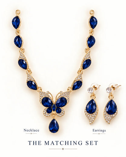 Navy blue butterfly necklace and earrings matching set shown side by side